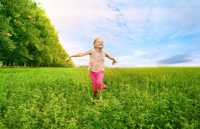 Girl run on green field