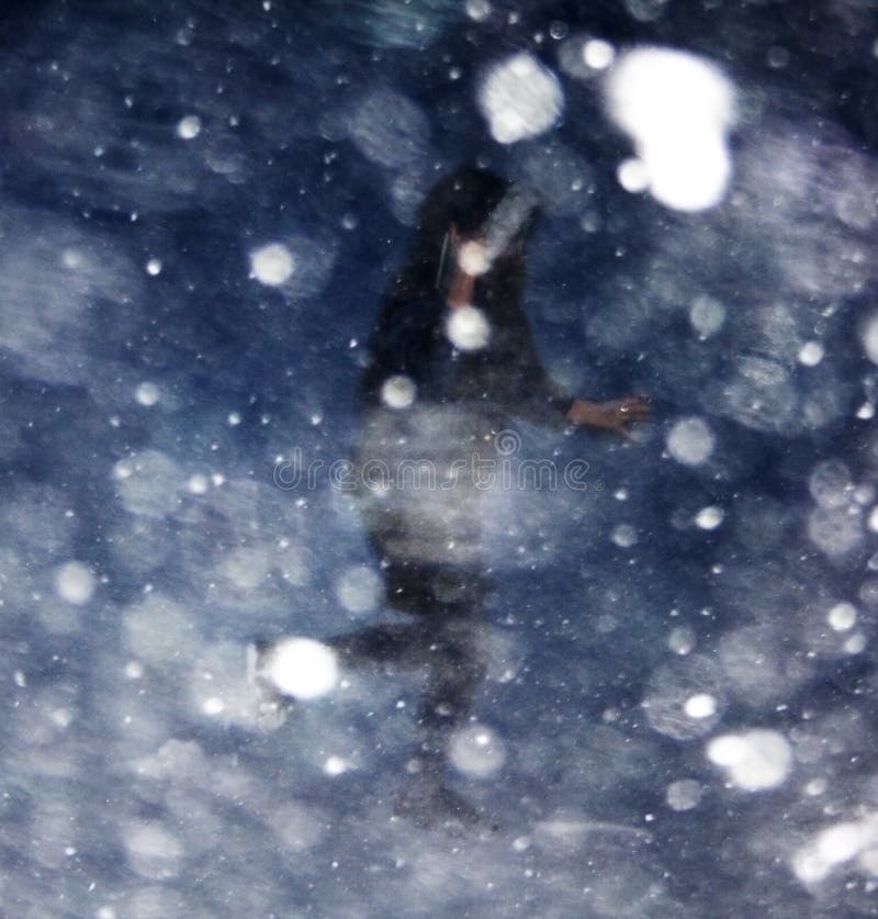 Girl running in blizzard bokeh