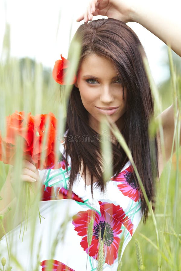 Girl running in poppy field