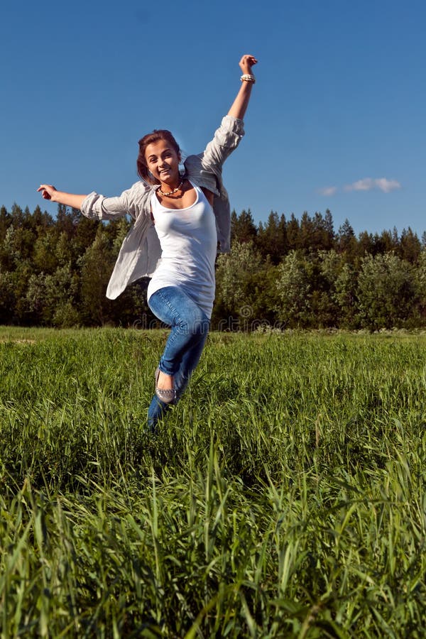 Girl runs across the green grass