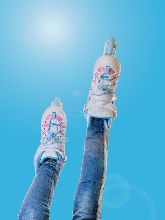 Girl`s Feet in Roller Skates on Blue Background with Glare Stock Photo ...