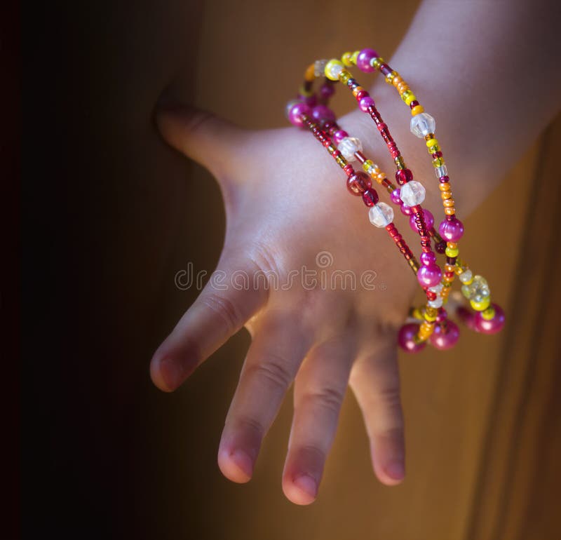 Girl s hand with bracelets stock photo. Image of fingernail 56519336