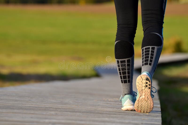Girl`s legs in running shoes starting to run - back. Girl`s legs in running shoes starting to run - back