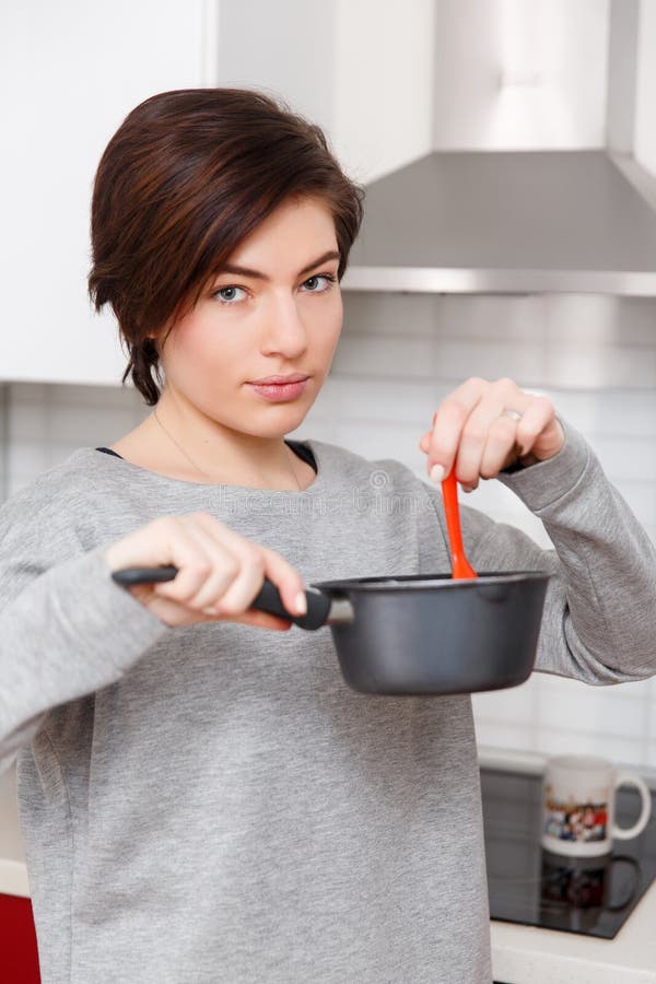 Girl with saucepan in hand stock image Girl with saucepan in hand stock image