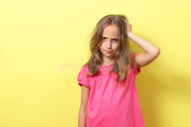 The Girl Is Scratching Her Head On A Colored Background Stock Image