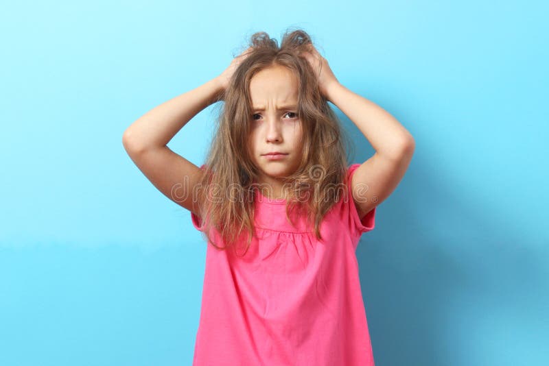 The Girl Is Scratching Her Head On A Colored Background Stock Image Image Of Little Annoyed