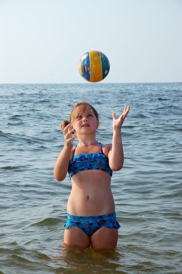 Girl, sea and ball