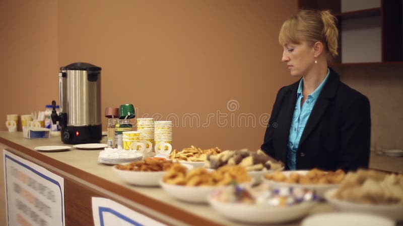 Girl secretary prepares bar for a coffee break