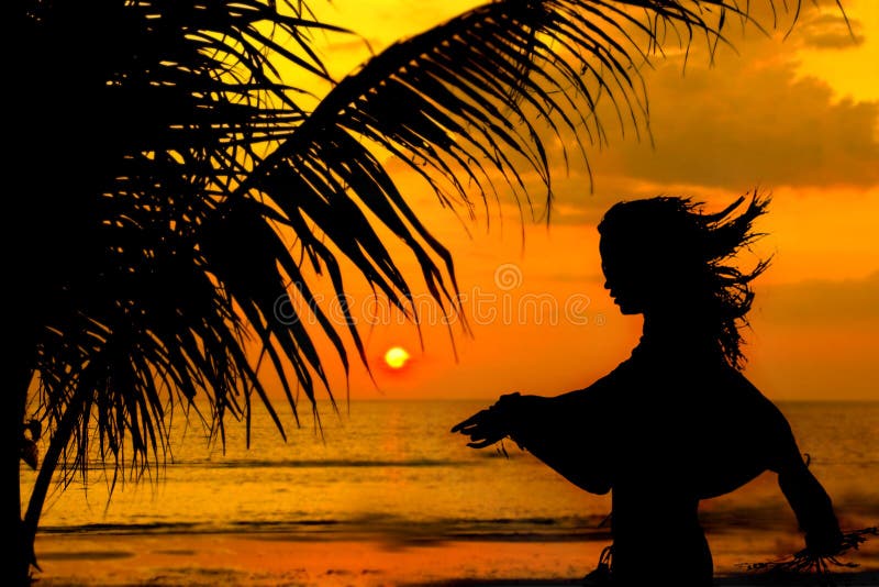 Girl silhouette on beach at sunset