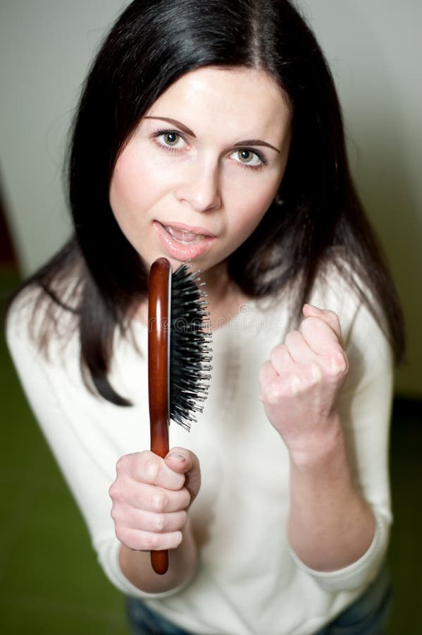 Girl singing on her hairbrush. 