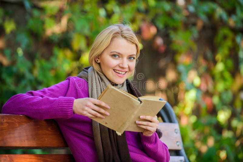 Girl sit bench relaxing with book fall nature background. Lady bookworm read book outdoors fall day. Woman reading book.