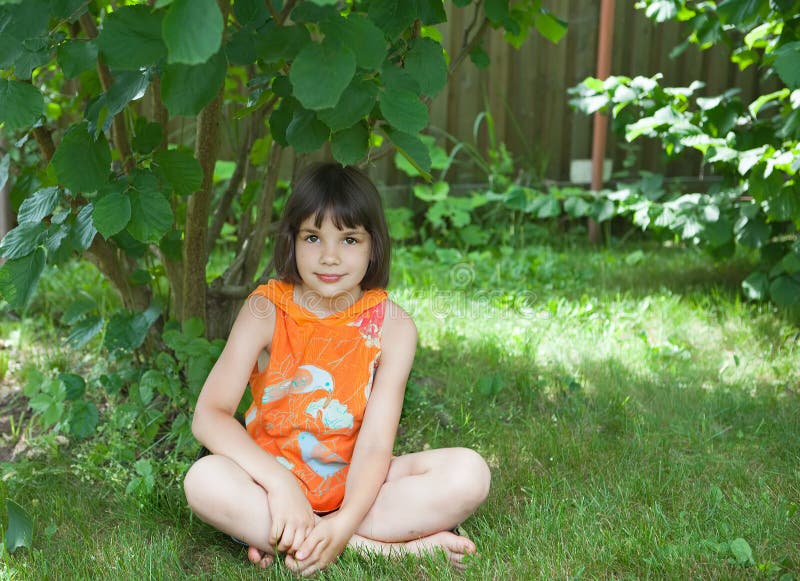 The Girl Sits on a Grass Under a Bush Stock Image - Image of human ...