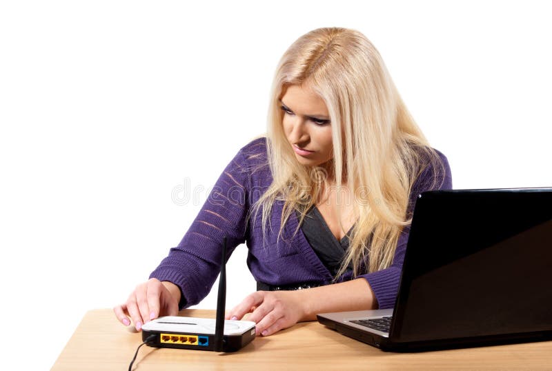 A girl sits at a laptop