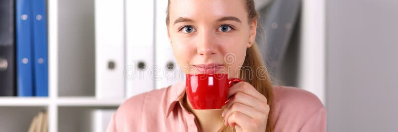 Girl sits office front computer and drinks coffee stock photos Girl sits office front computer and drinks coffee stock photos