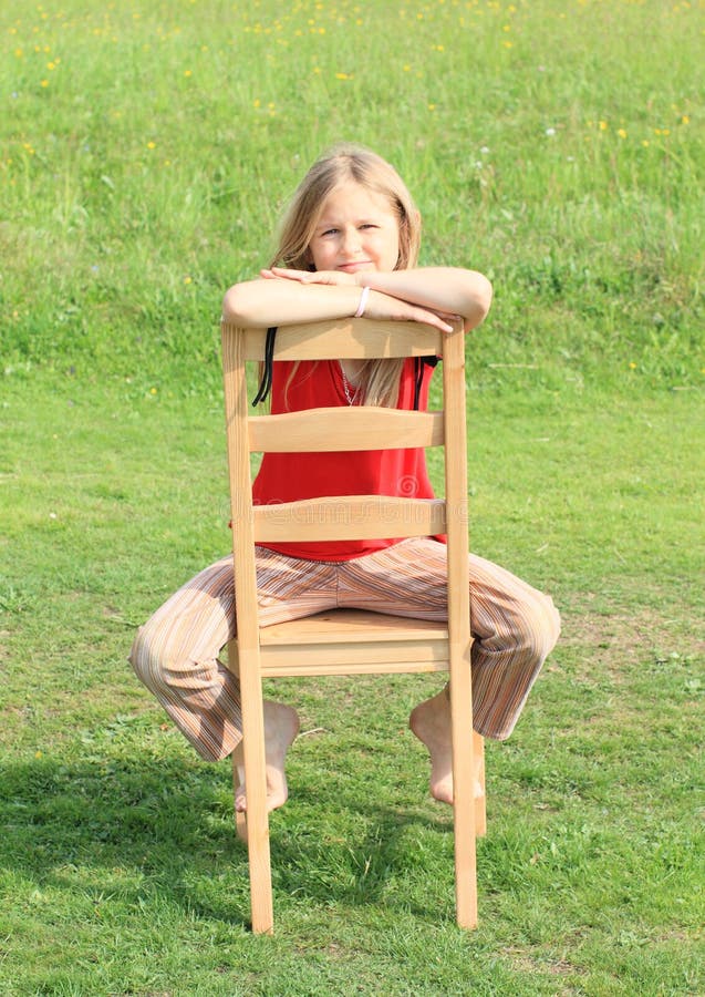 Girl sitting on chair stock image. Image of childhood