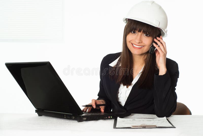 Girl sitting in the construction helmet