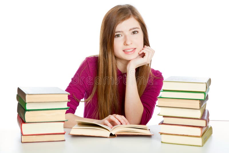 Girl is sitting at the desk and reading book