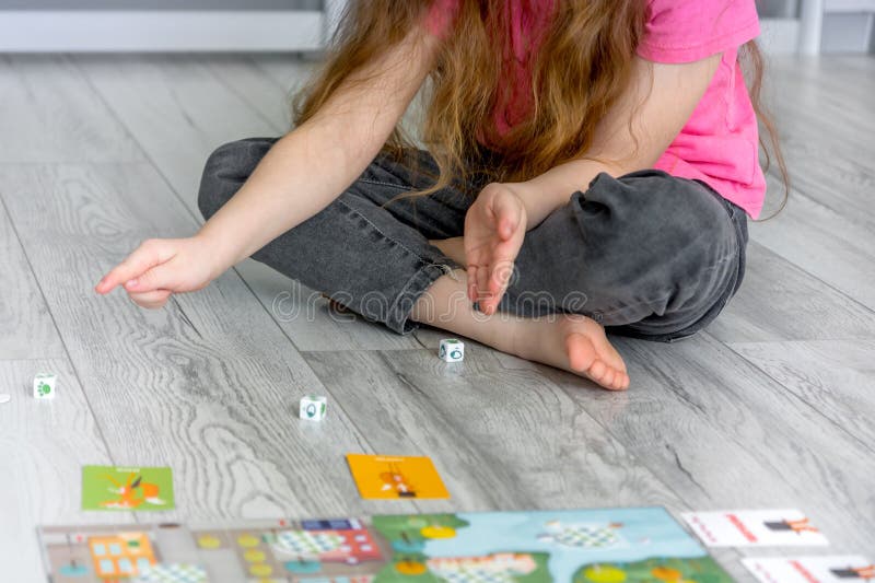 Girl Sitting on the Floor Throws Dice Stock Photo Image of lifestyle, pastime 275652878