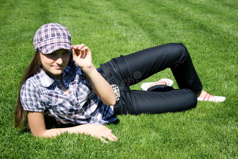 Girl sitting on the green grass