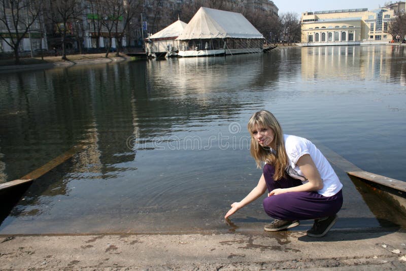 Girl sitting near pond