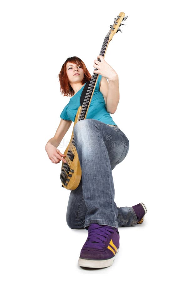 Girl sitting on one knee and playing bass guitar