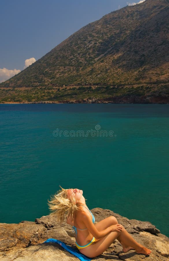 Girl sitting on a rock