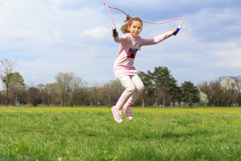 Girl with skipping rope in the field