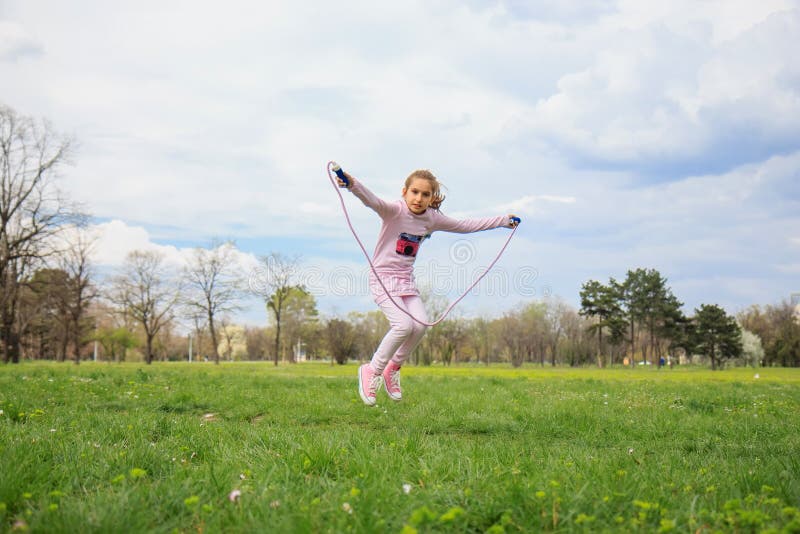 Girl with skipping rope in the field