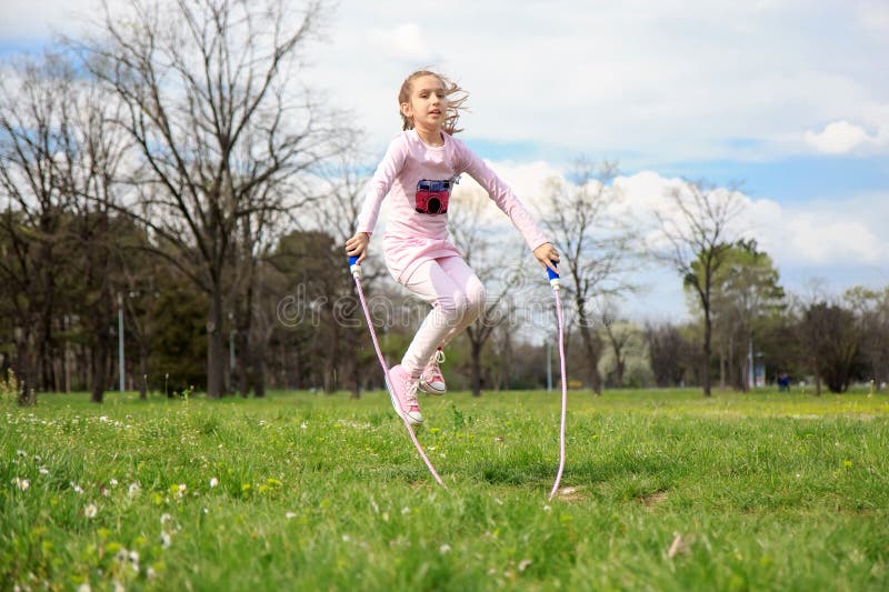 Girl with skipping rope in the field