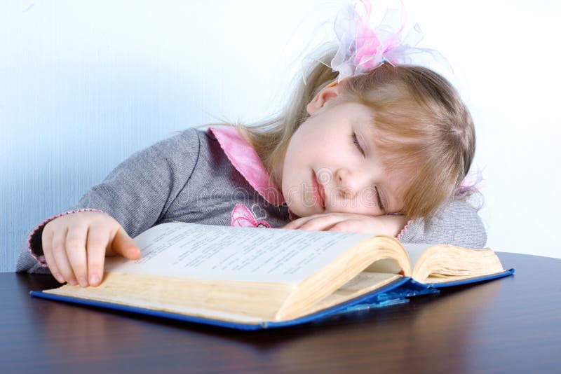 Girl sleeping on book
