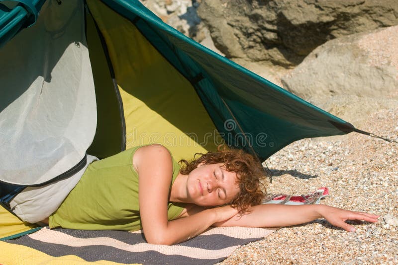 Girl sleeping near of tent