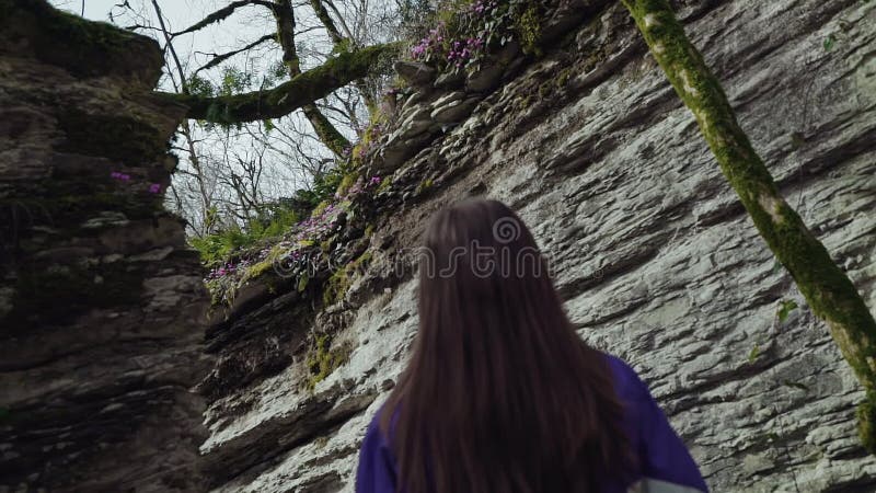 A girl slowly walks in the mountain labyrinth stock footage