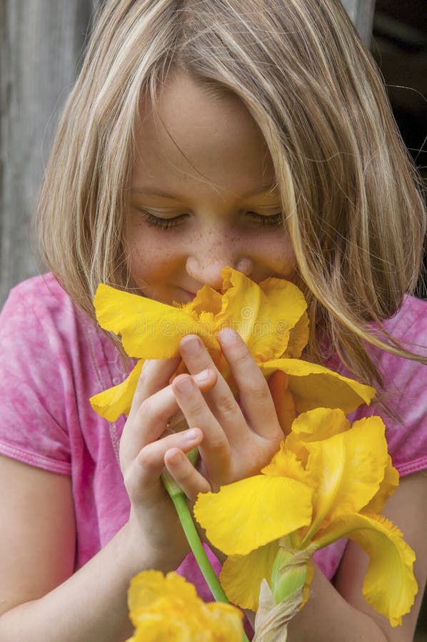 Girl smelling Iris flowers stock photo. Image of spring 40952880