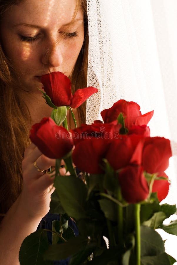 Girl smelling red roses