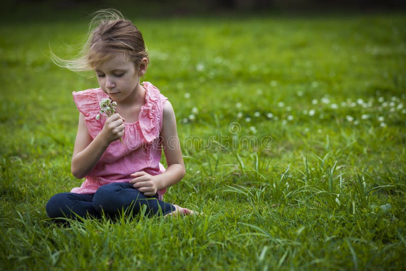 Girl Smelling Wild Flowoers royalty free stock photography Girl Smelling Wild Flowoers royalty free stock photography
