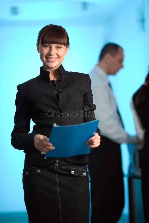Girl with smile and with blue folder and men