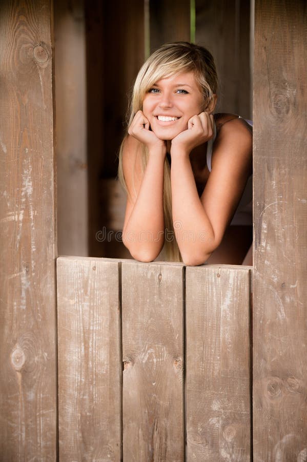 Girl smiles from shed