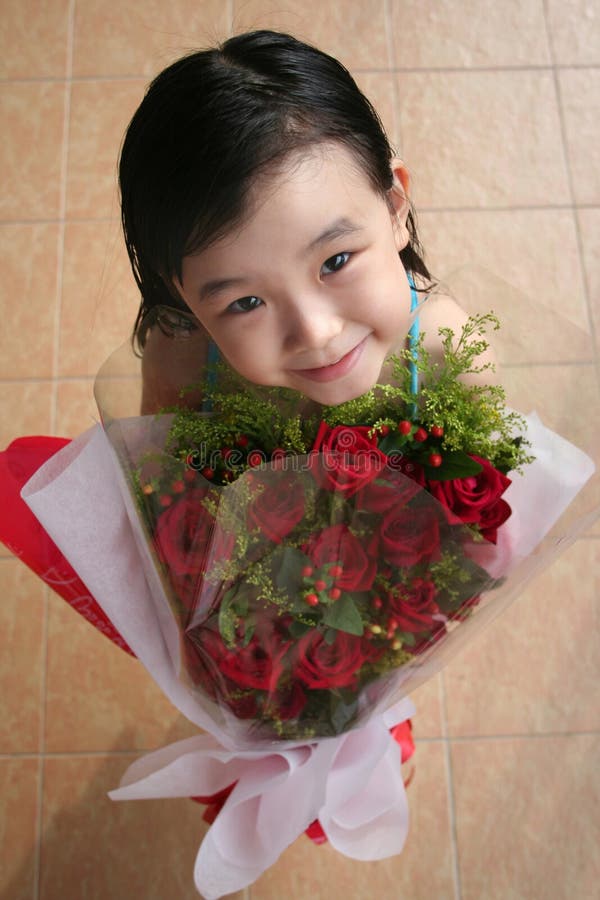 Girl smiling & holding bouquet of roses