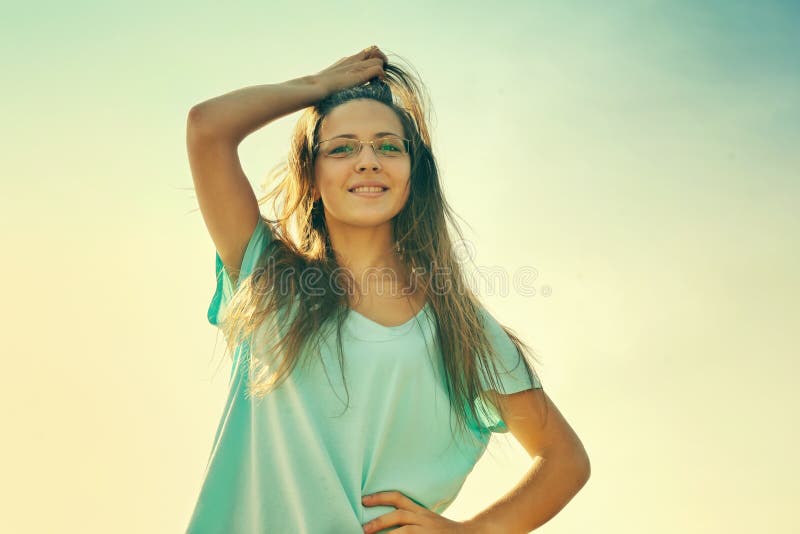 Girl smiling joyful, friendly and charming looking at camera on warm sunny summer day