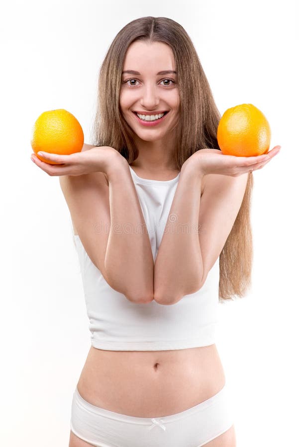 Girl smiling with oranges