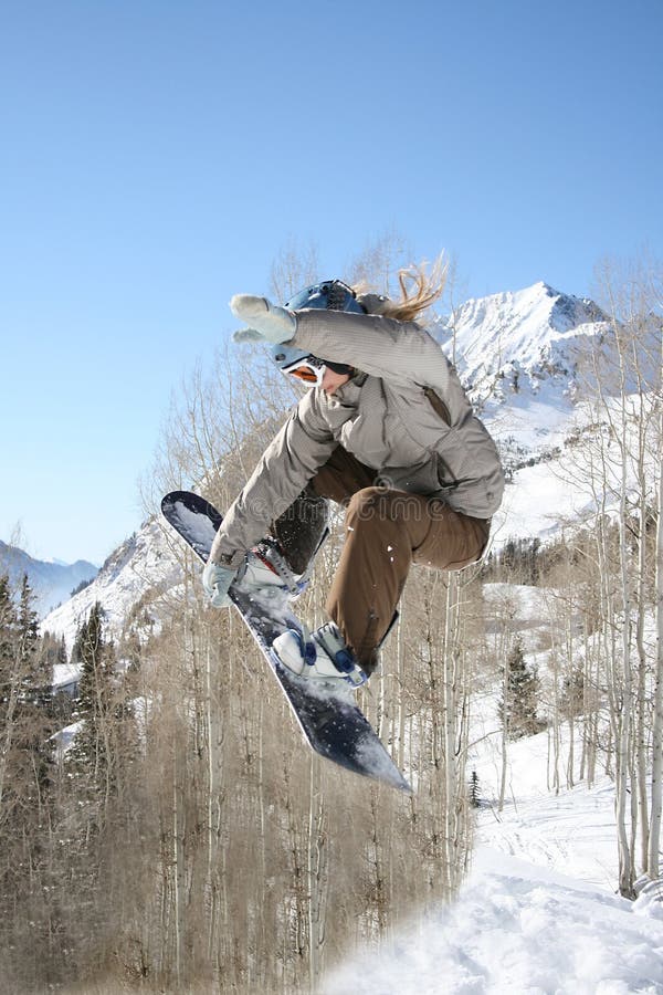 girl snow boarder hits jump