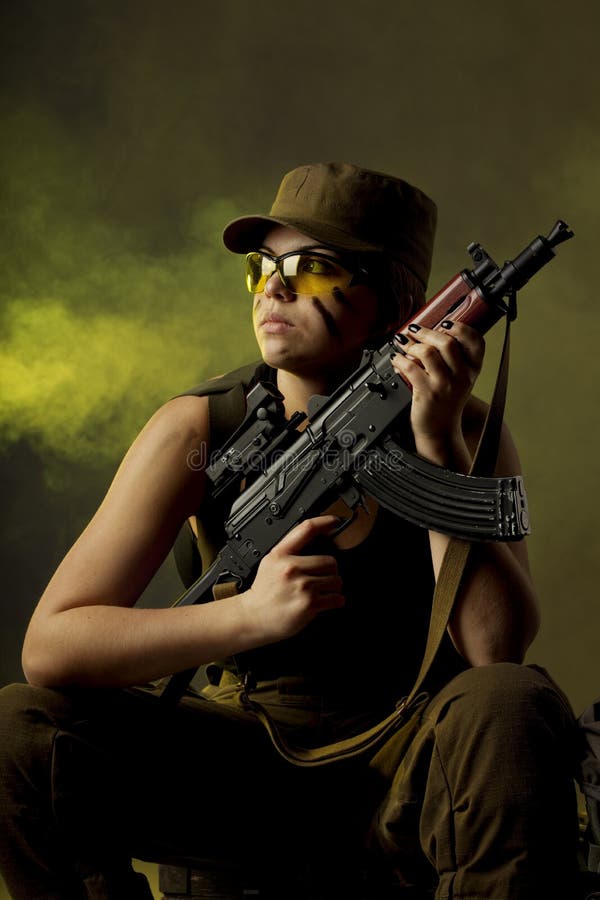 Girl soldiers in the smoke stock image
