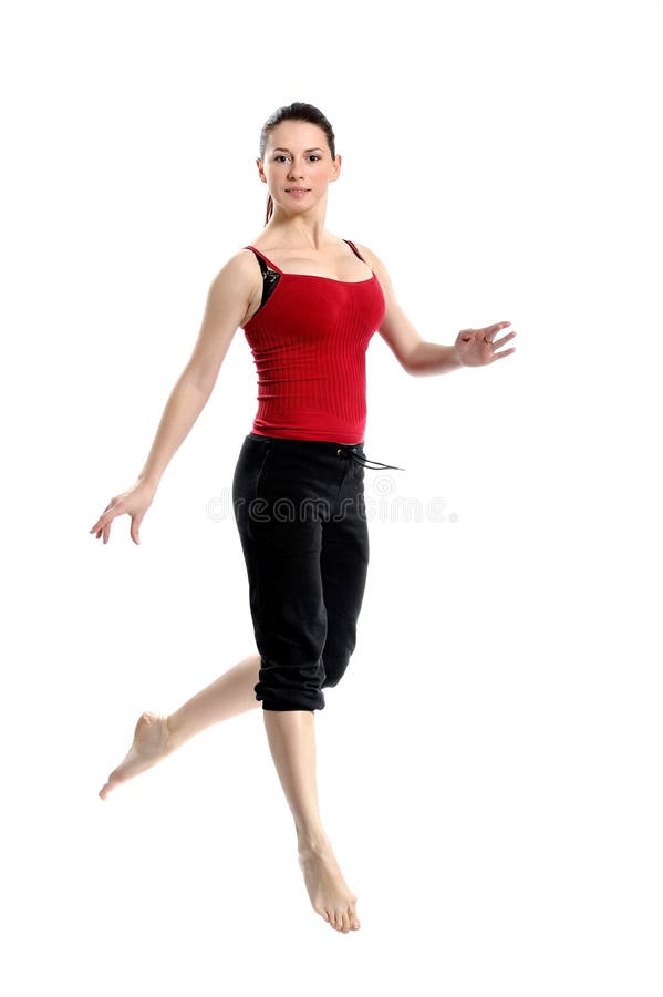 Girl in sportswear jumping over white