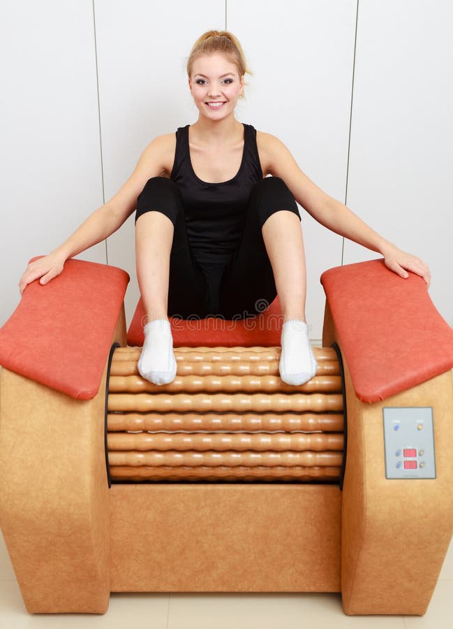 Girl in sportwear on relax massage equipment healthy spa salon