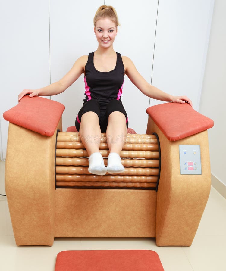 Girl in sportwear on relax massage equipment healthy spa salon