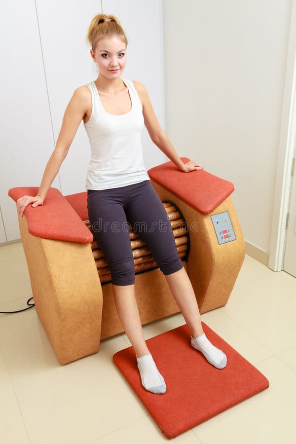 Girl in sportwear on relax massage equipment healthy spa salon