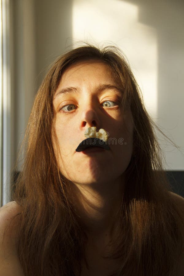 A Girl Catches Falling Snowflakes By Opening Her Mouth And Sticking Out 