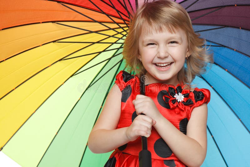 Girl standing under colorful umbrella