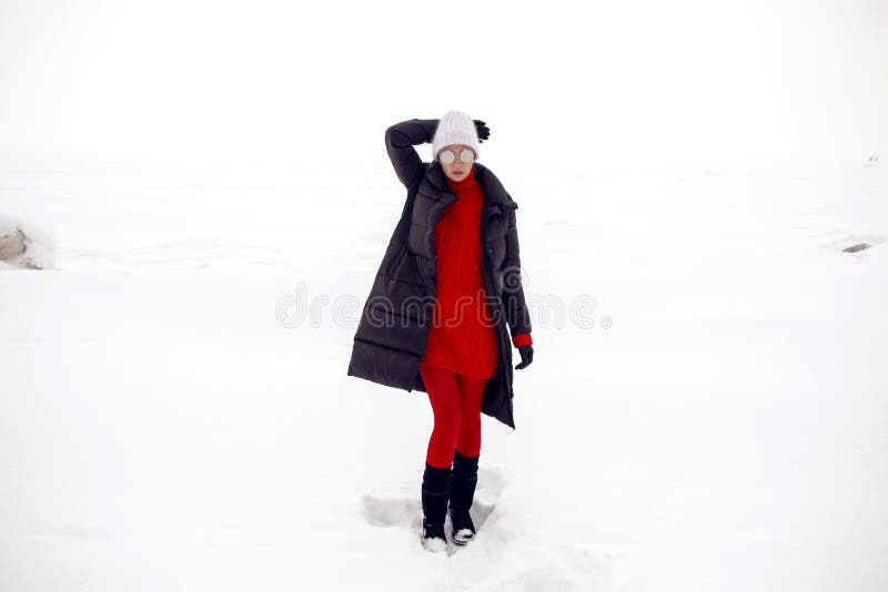 Girl stands in a snowy field in a jacket stock photography Girl stands in a snowy field in a jacket stock photography
