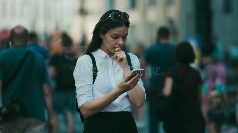 Girl on the street among the crowd of passers-by, photos in the style of surveillance